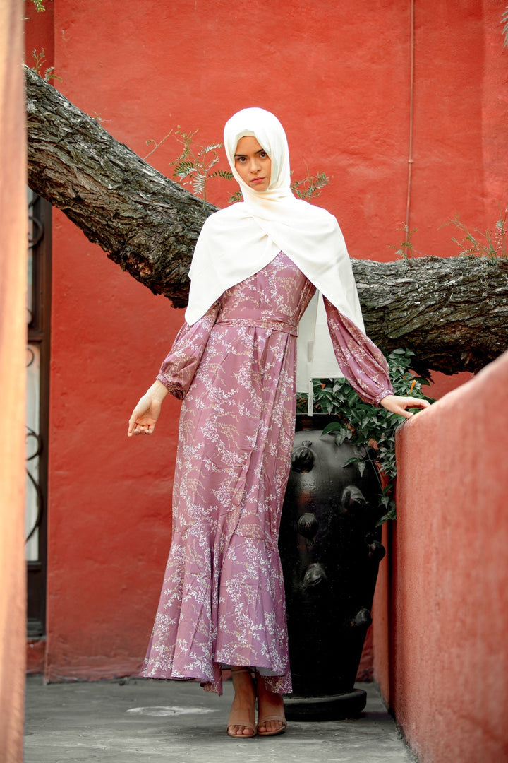 Woman in a floral ruffle faux wrap maxi dress with white hijab, showcasing rose floral design