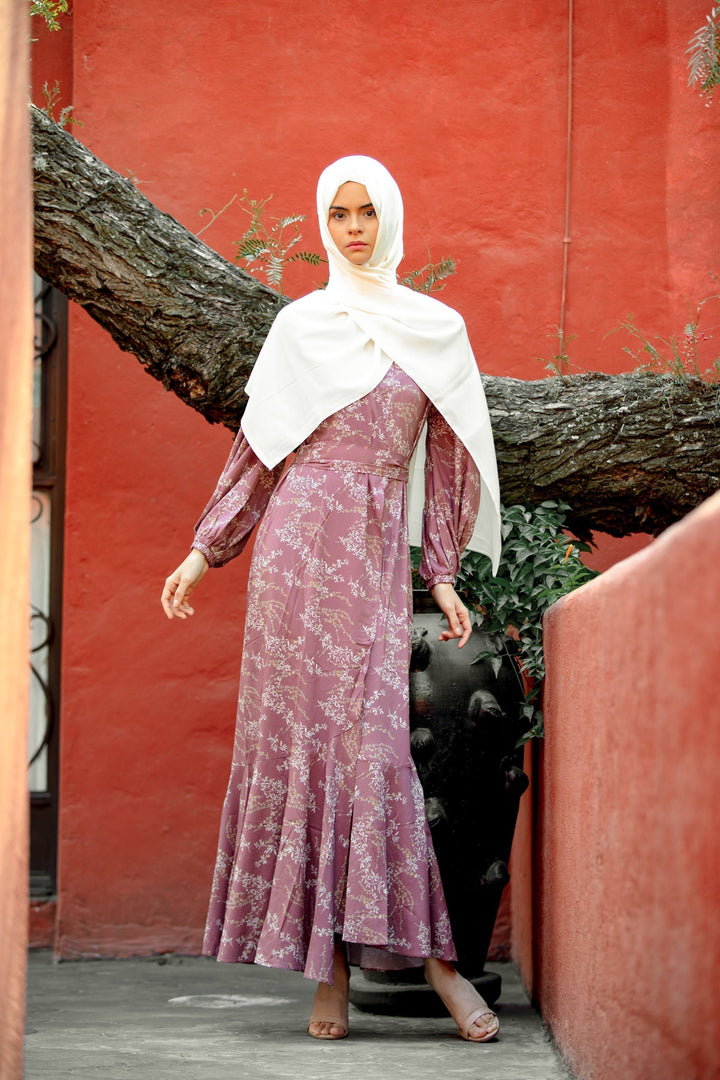 Woman in a floral dress and hijab showcasing the Rose Floral Ruffle Faux Wrap Maxi Dress