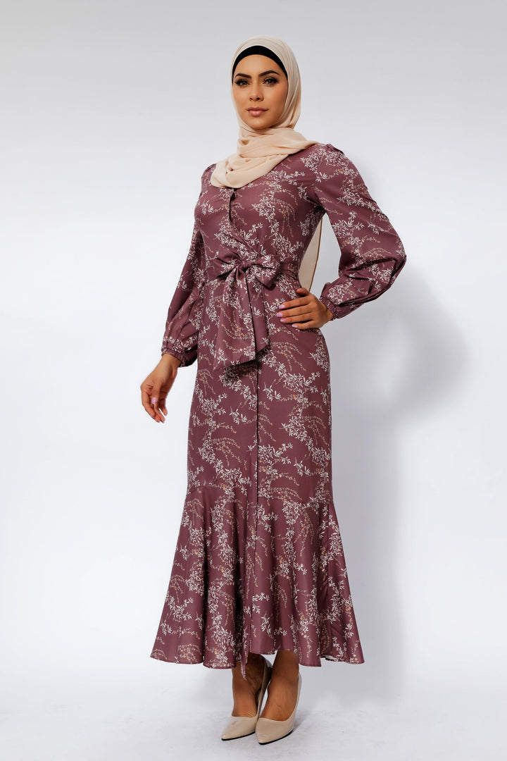 Woman in a long-sleeved rose floral ruffle faux wrap maxi dress with a hijab