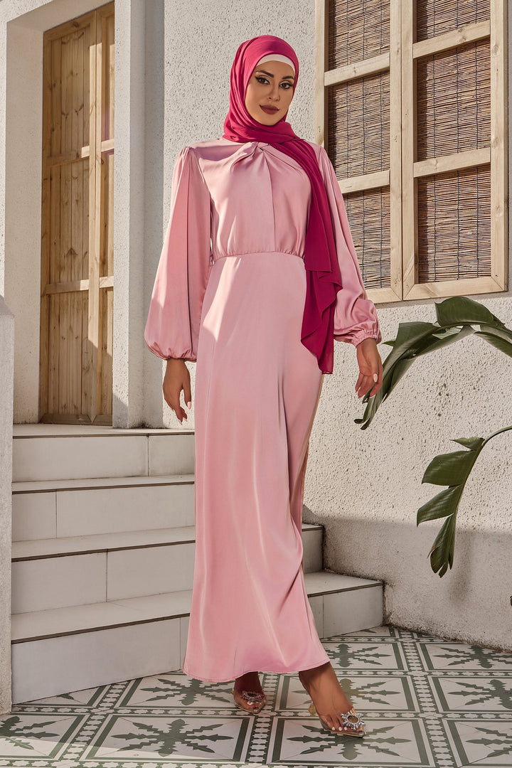 Woman in pink dress and hijab showcasing Rose Knot Criss Cross Satin style