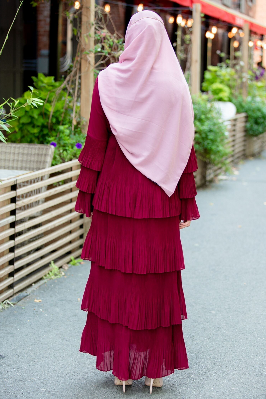 Burgundy tiered dress with pink hijab featuring rhinestone trim chiffon details