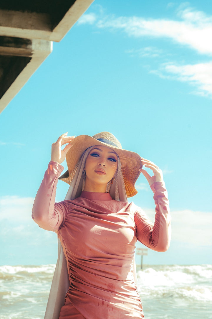 Woman in a pink dress and sunhat modeling a Ruched 3 Piece Modest Swimsuit on clearance