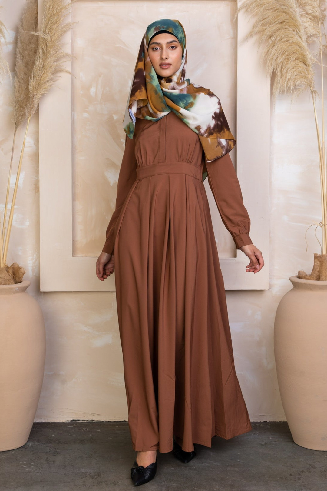 Brown long-sleeved maxi dress with colorful hijab and zipper closure detail