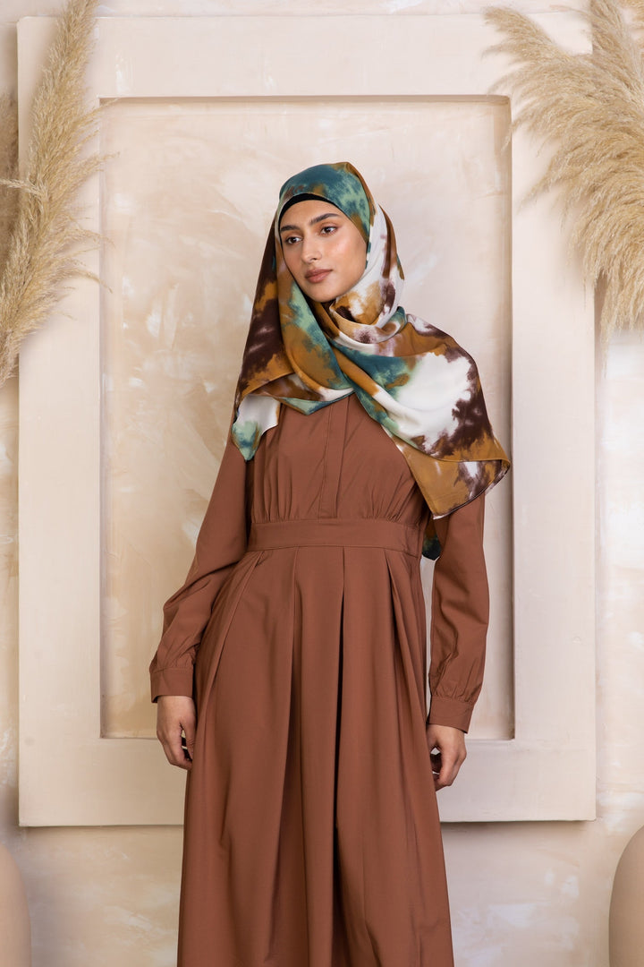 Woman in brown dress with patterned hijab modeling Rusty Brown Lattice Abaya Maxi Dress with zipper closure