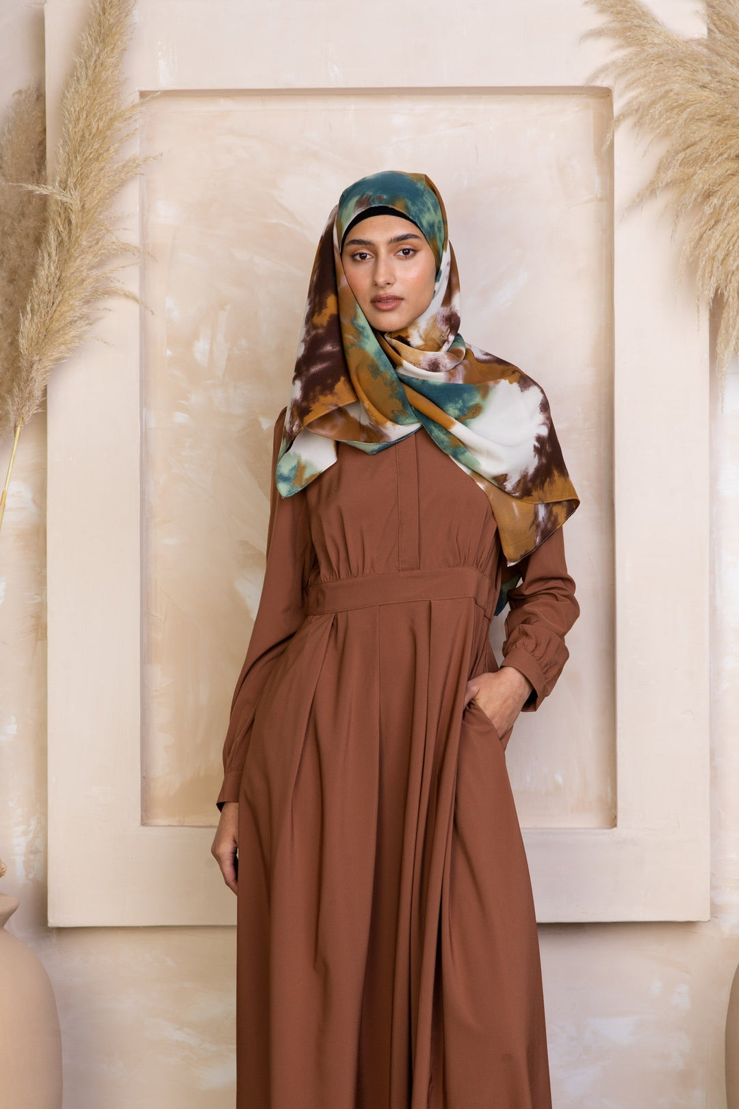 Woman in brown dress and patterned hijab wearing Rusty Brown Lattice Abaya with zipper closure