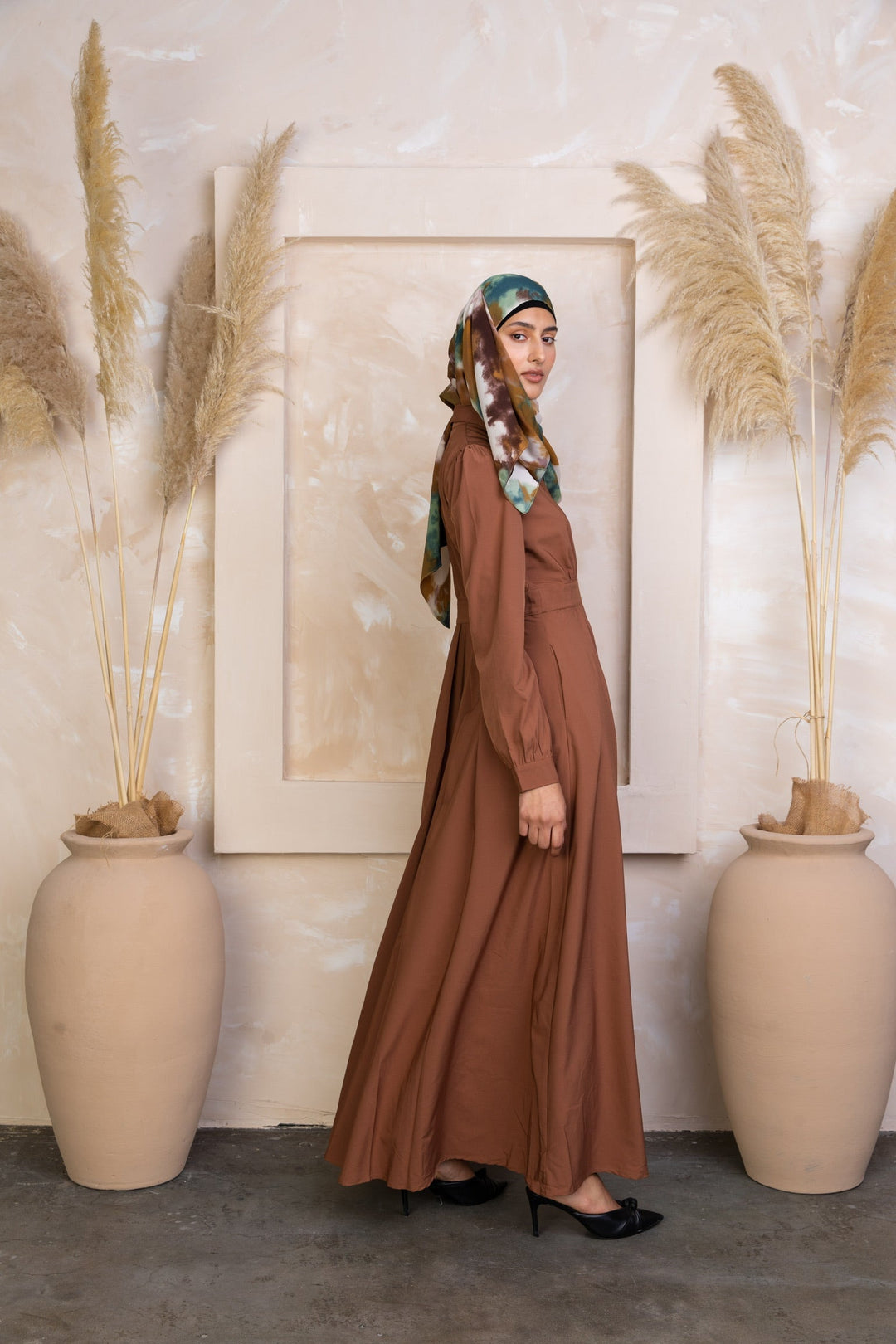 Woman in Rusty Brown Lattice Abaya Maxi Dress with zipper closure and patterned hijab