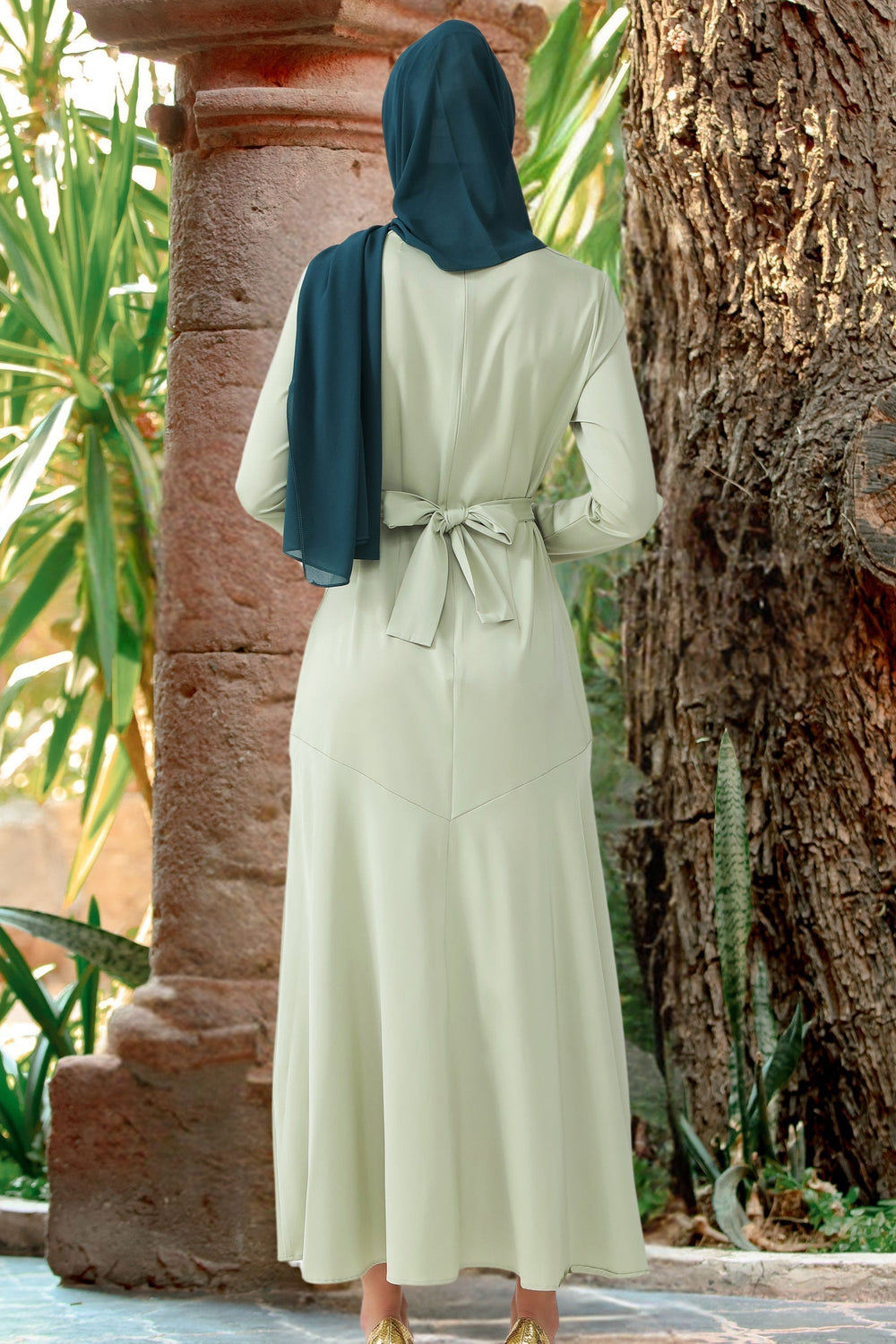 Light green modest dress with dark blue hijab showcasing Sage Green Criss Cross Satin Maxi Dress