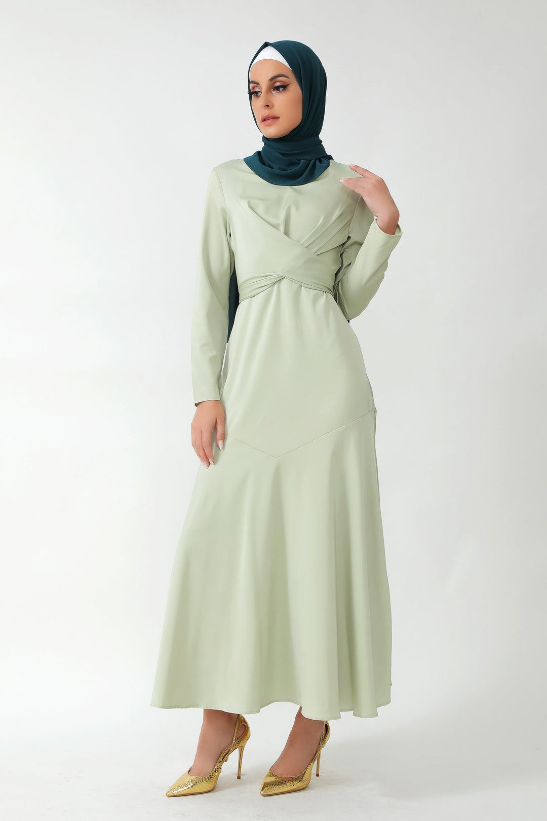 Woman wearing Sage Green Criss Cross Satin Long Sleeve Maxi Dress with dark green hijab