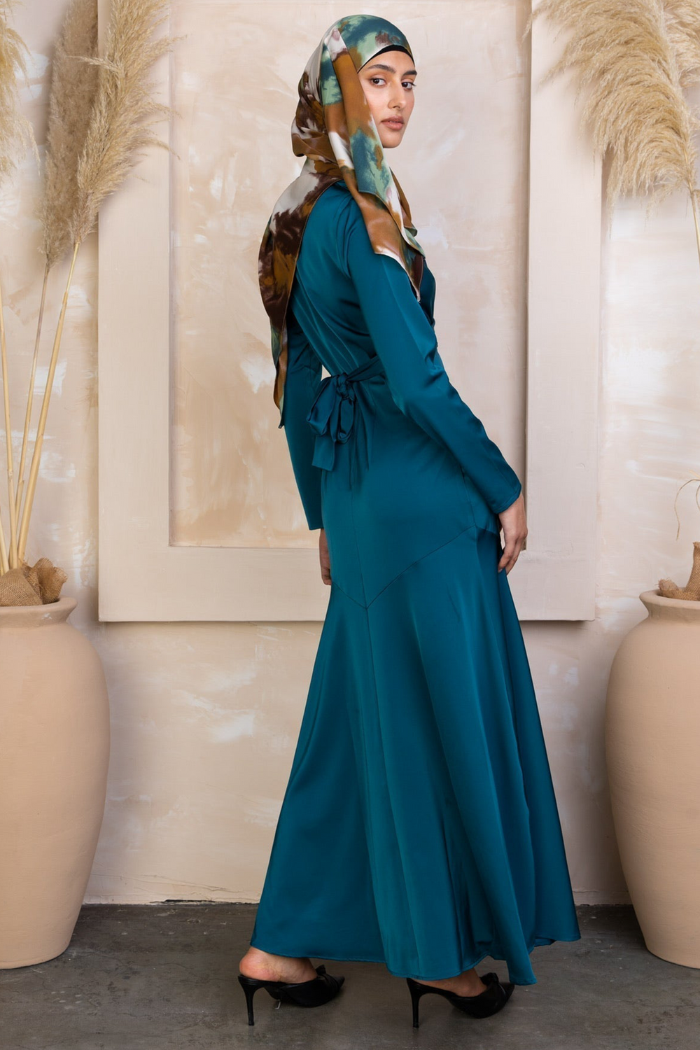 Teal Sapphire Criss Cross Satin Maxi Dress with matching headscarf on display