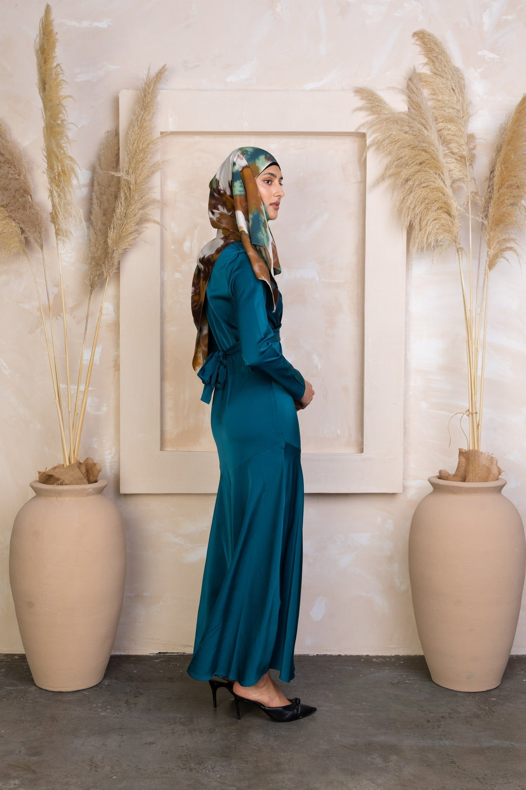 Teal satin dress with headscarf showcasing the Sapphire Criss Cross Satin Maxi Dress