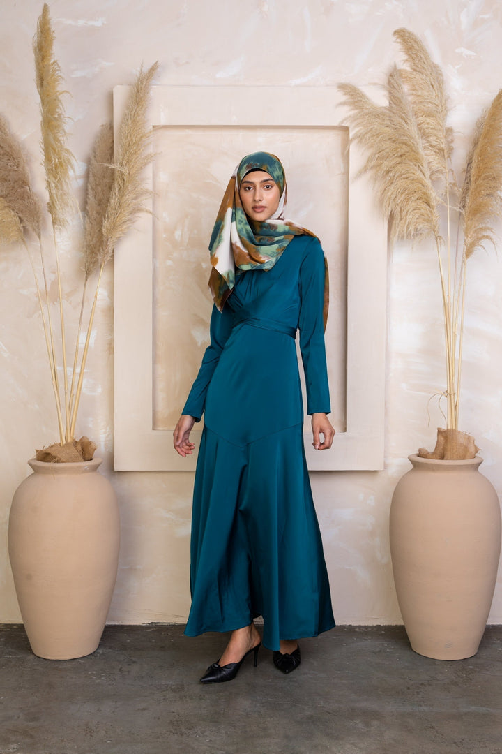 Woman in teal dress and patterned hijab wearing Sapphire Criss Cross Satin Maxi Dress