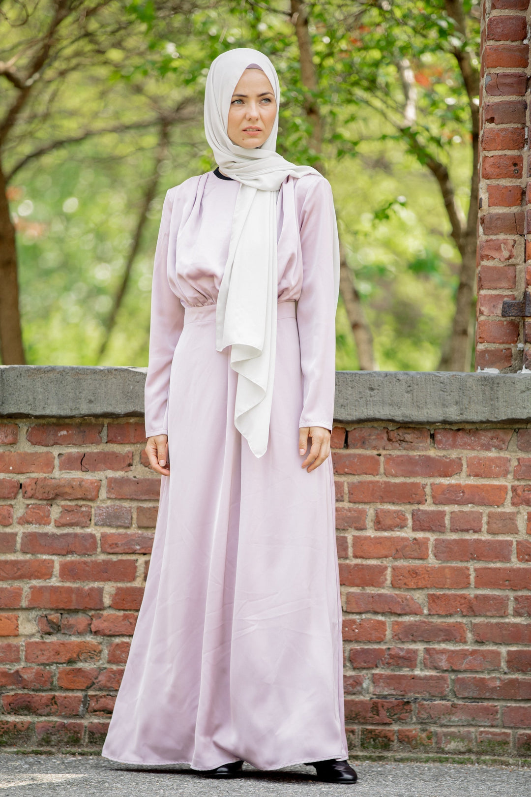 Woman in a light purple Satin Pleated Maxi Dress with a white hijab on clearance