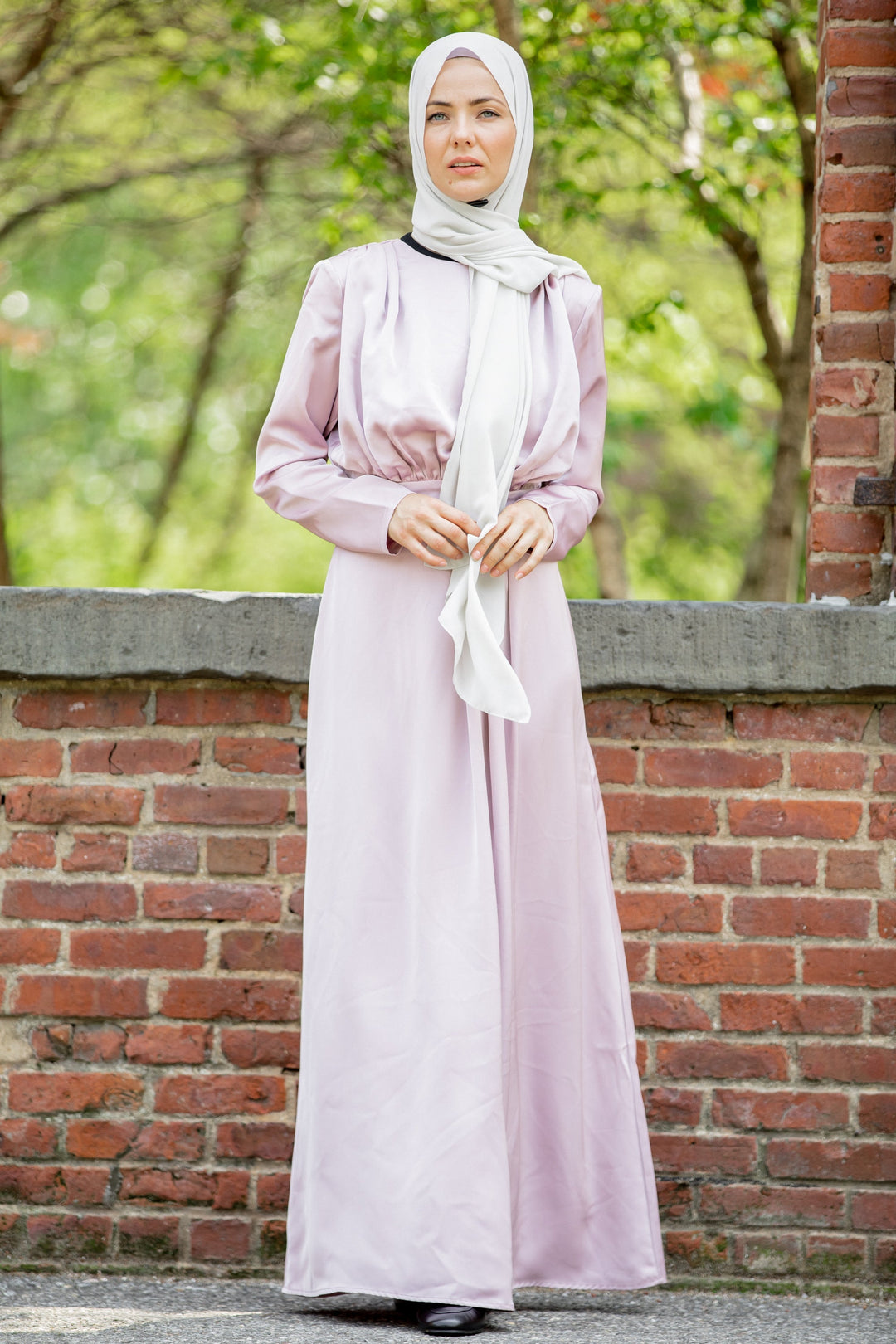 Woman in Satin Pleated Maxi Dress showcasing elegance and modesty with hijab