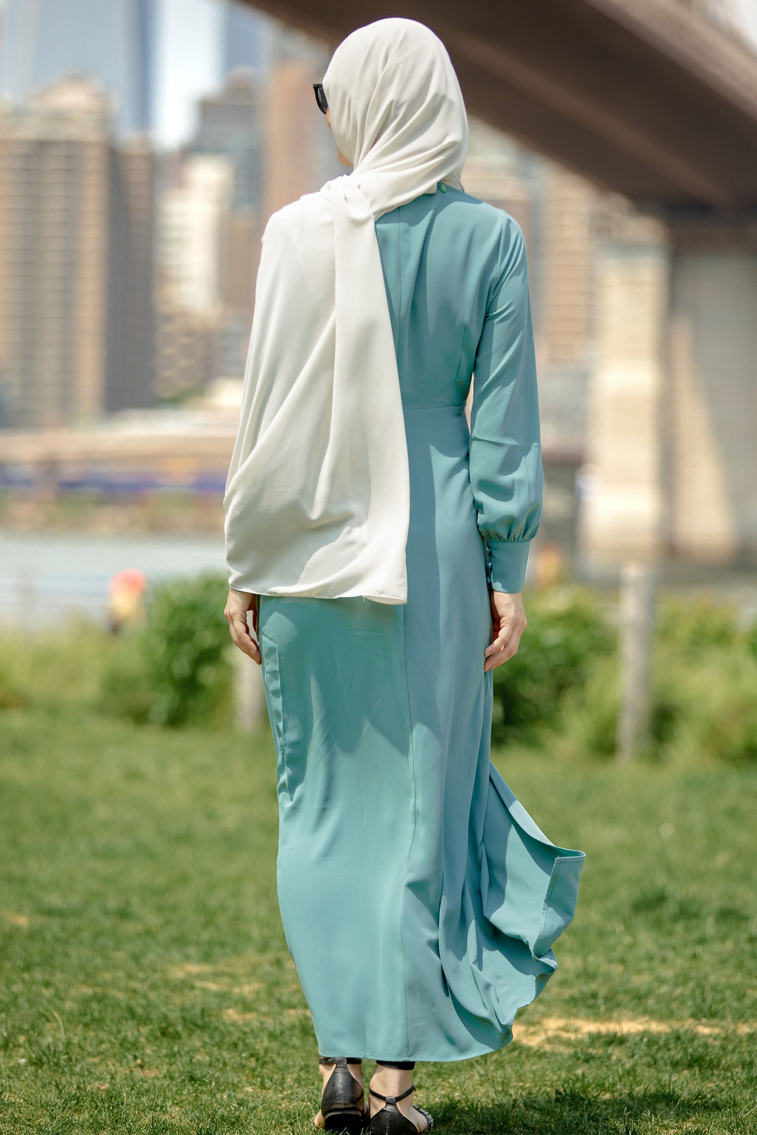 Woman in teal hijab wearing Sea Blue Wrap Maxi Dress with criss cross neckline