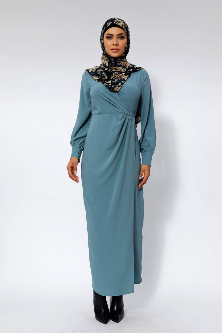 Long-sleeved teal blue wrap maxi dress with floral hijab and criss cross neckline