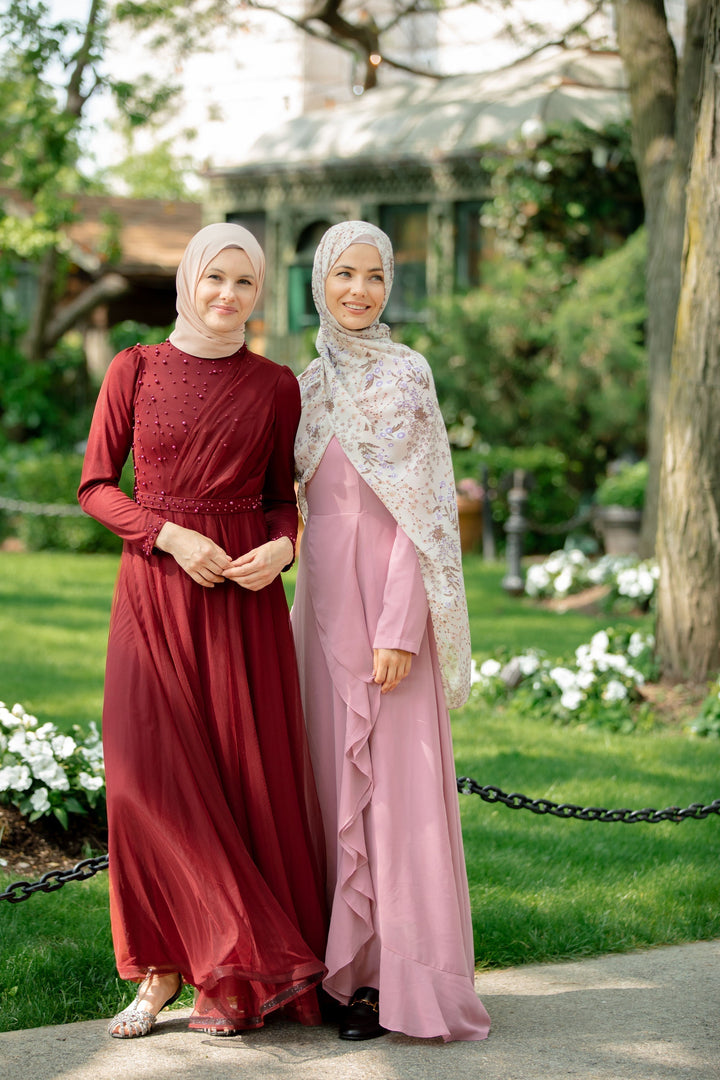 Two women in modest dresses and hijabs wearing elegant Pearl Gown maxi dresses