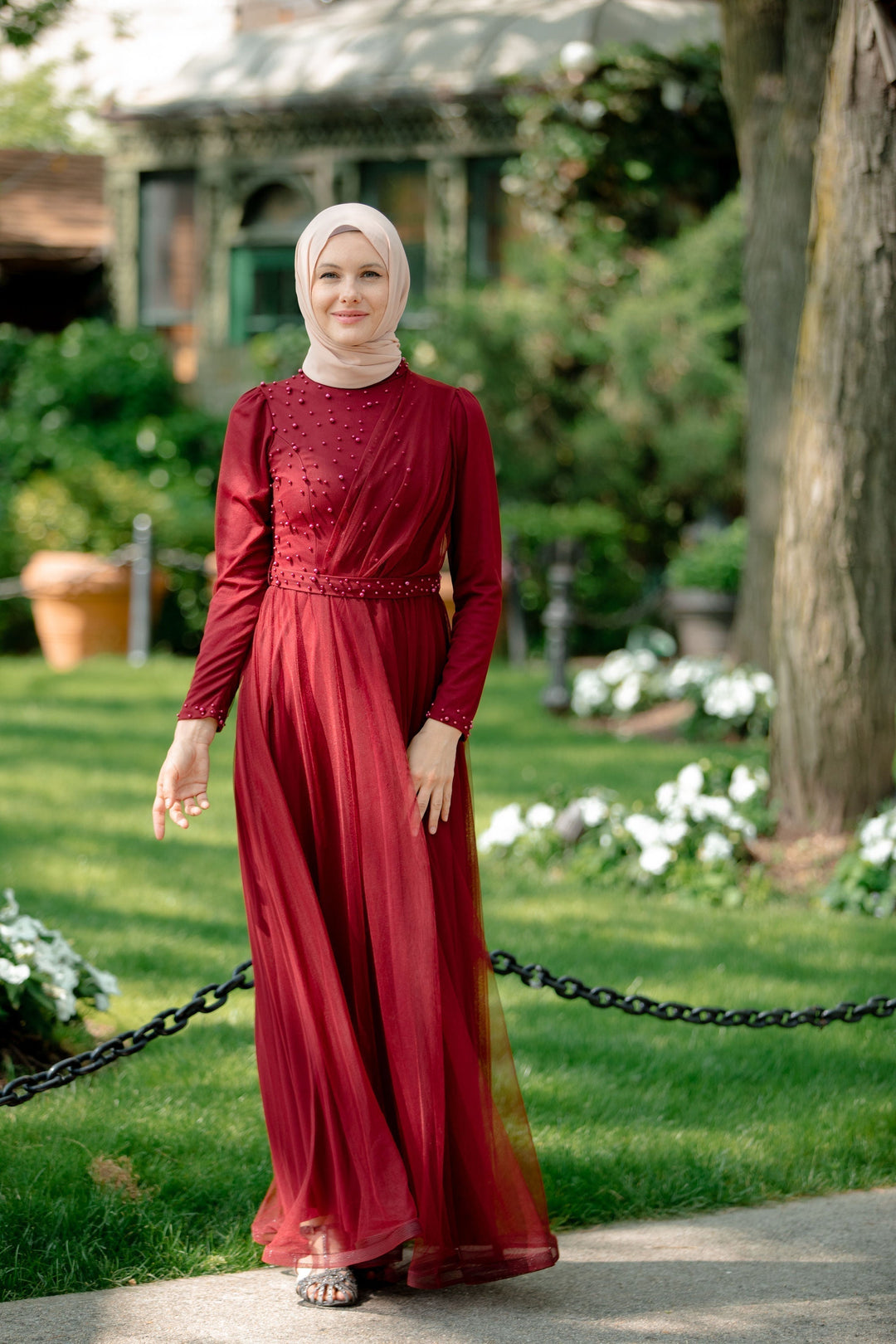 Burgundy long-sleeved pearl gown with hijab, perfect for elegant maxi dress styling