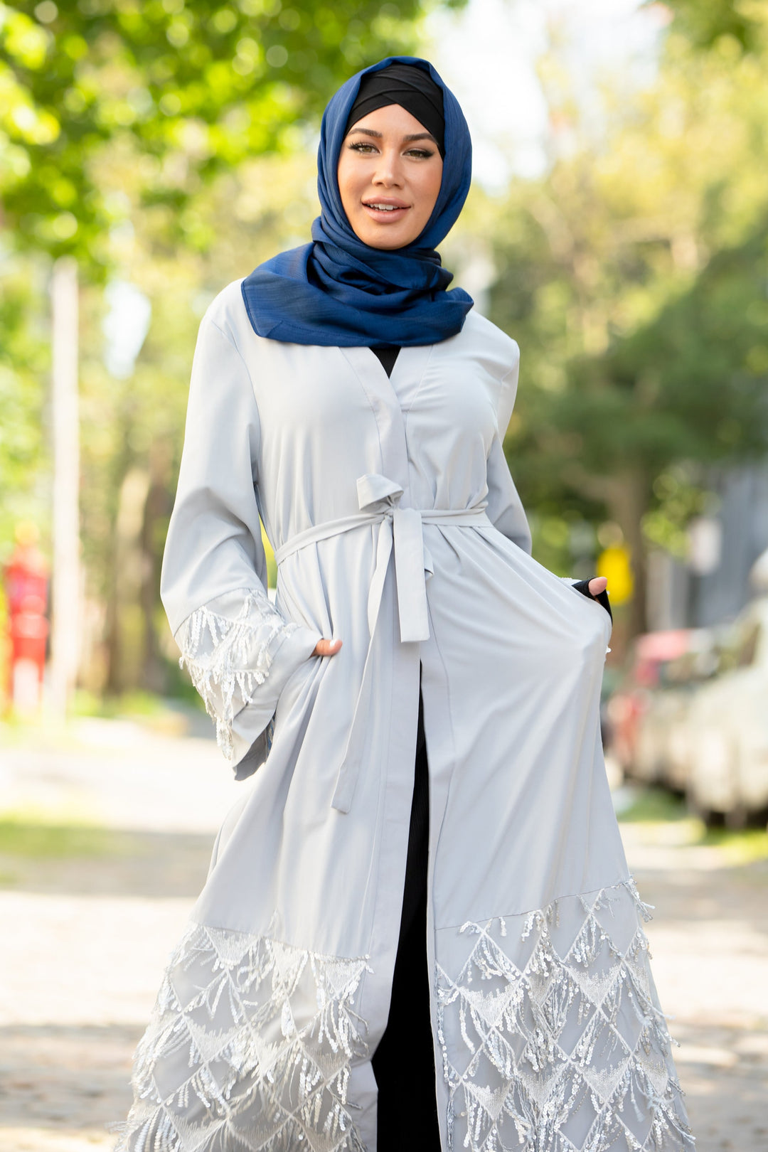 Woman in Silver Sequin Fringe Open Front Abaya with Blue Shimmer Hijab and kimono sleeves