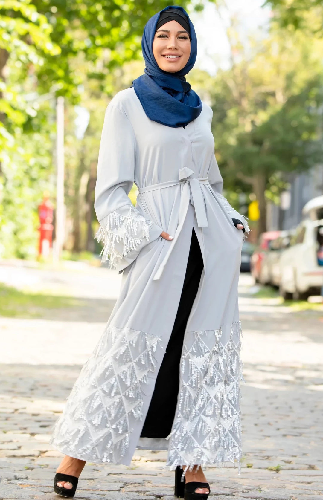 Woman in a Silver Sequin Fringe Open Front Abaya with Kimono Sleeves and Blue Shimmer Hijab