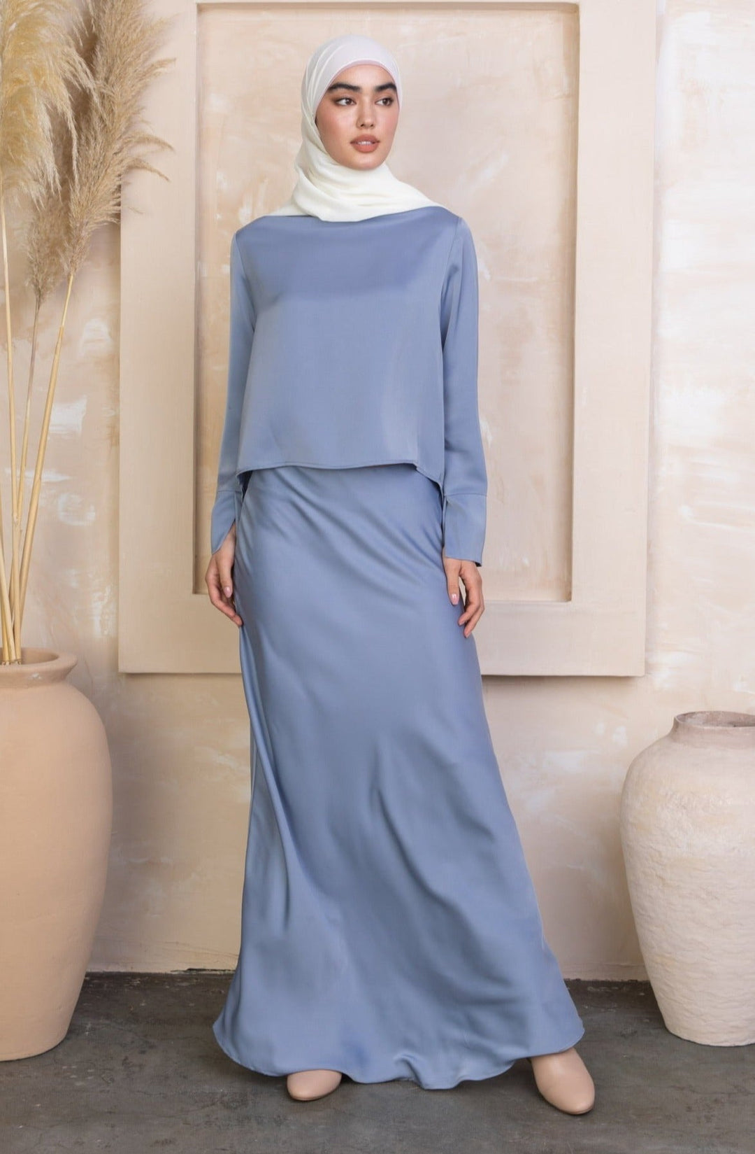 Woman in modest blue dress and white hijab wearing Sky Blue Satin Long Sleeve Skirt Set