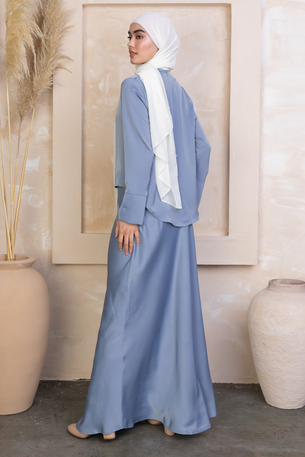 Modest blue satin long sleeve skirt set paired with a white hijab for elegant style