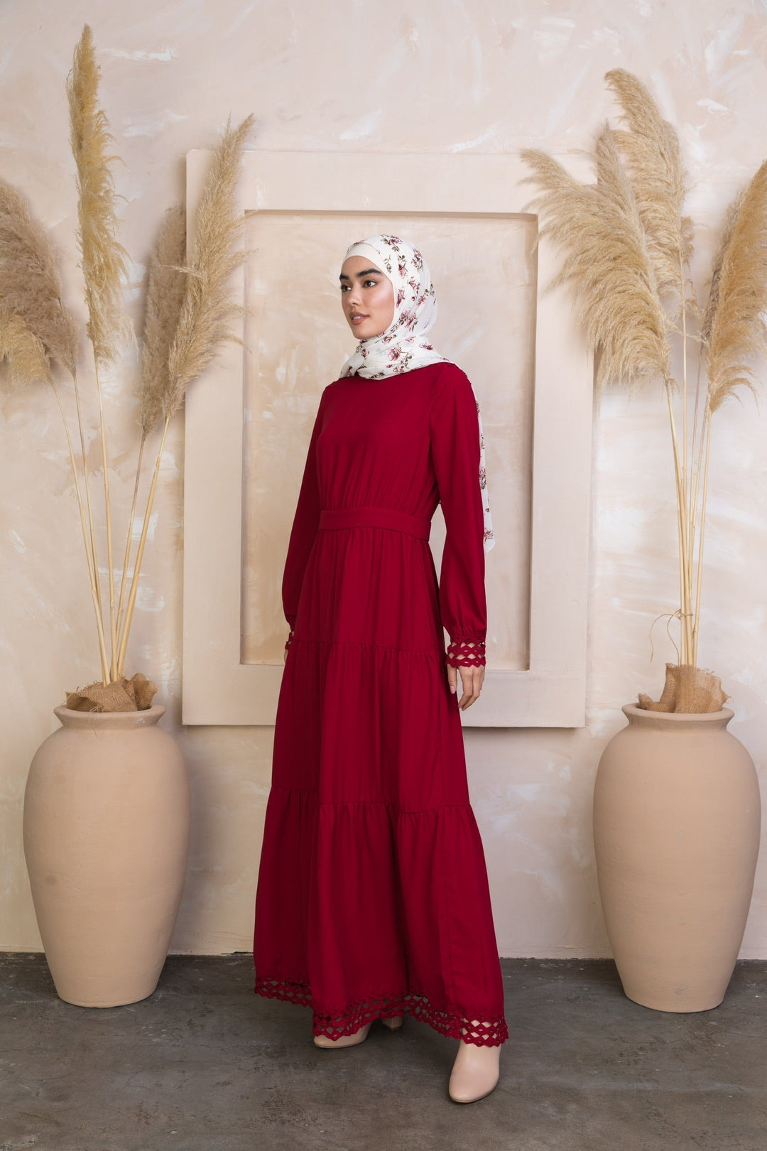 Long-sleeved Spiced Maroon Tiered Maxi Dress styled with a floral hijab