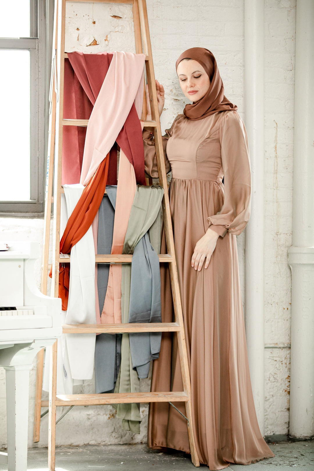 Woman in a long brown maxi dress and hijab, perfect for a special event, fully lined