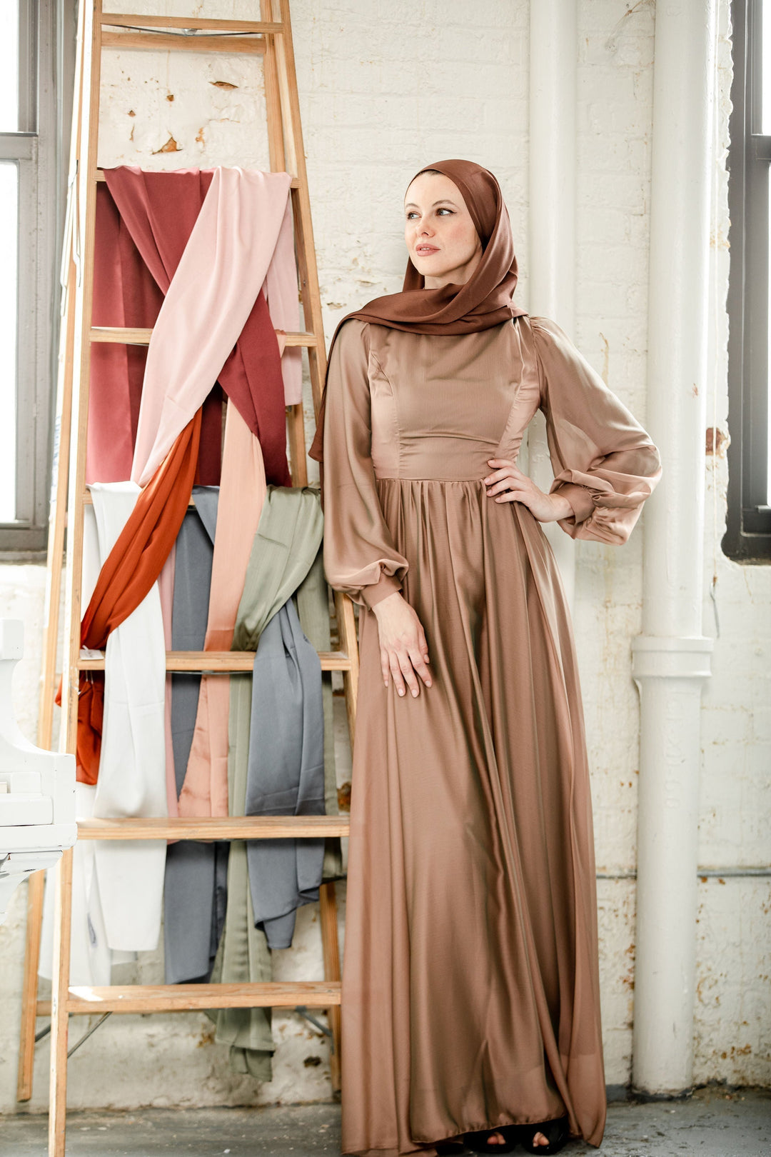 Woman in a fully lined Taupe Inaya Satin Gown maxi dress for a special event