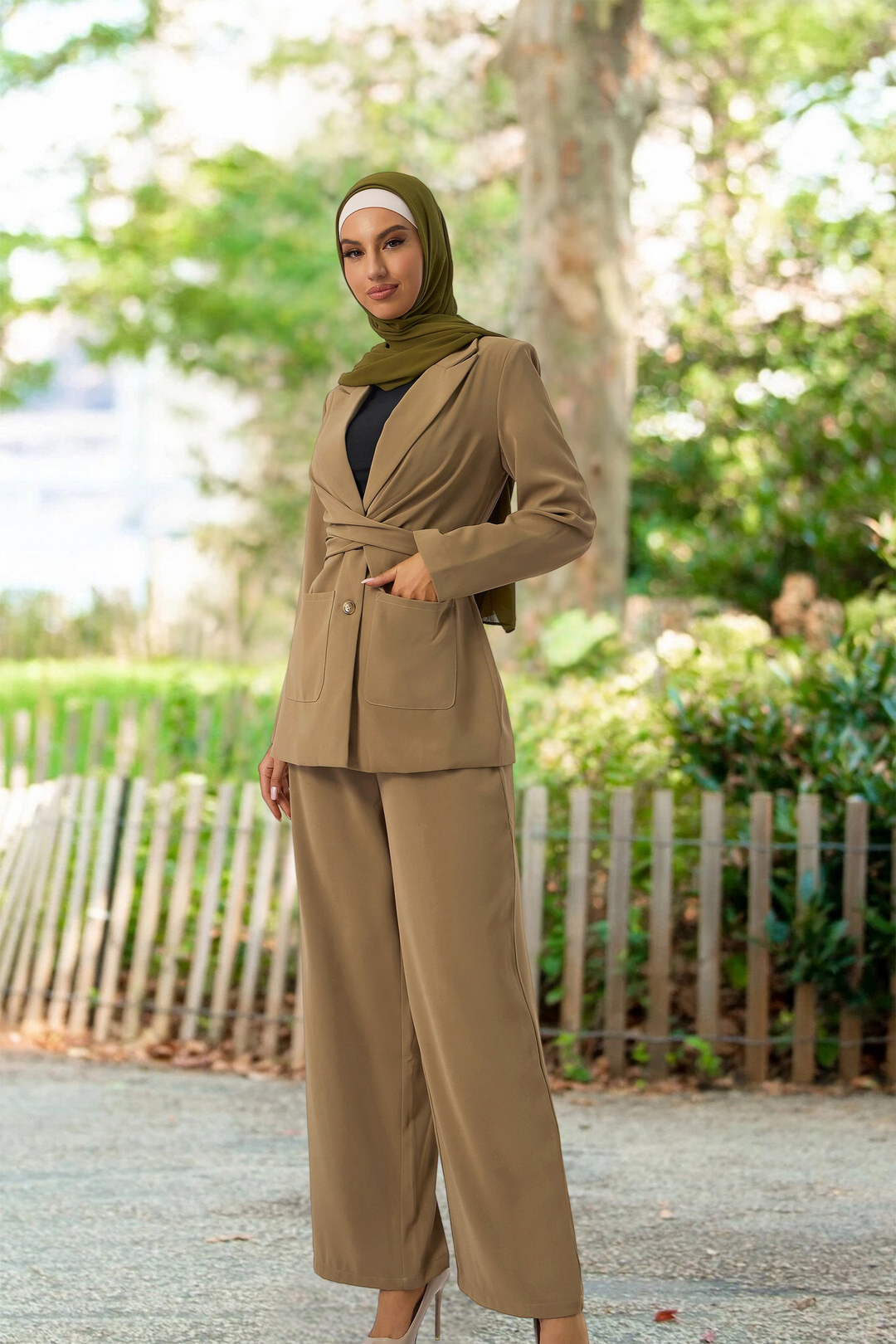 Woman in a tan pantsuit and hijab featuring taupe jacket and pants suit set