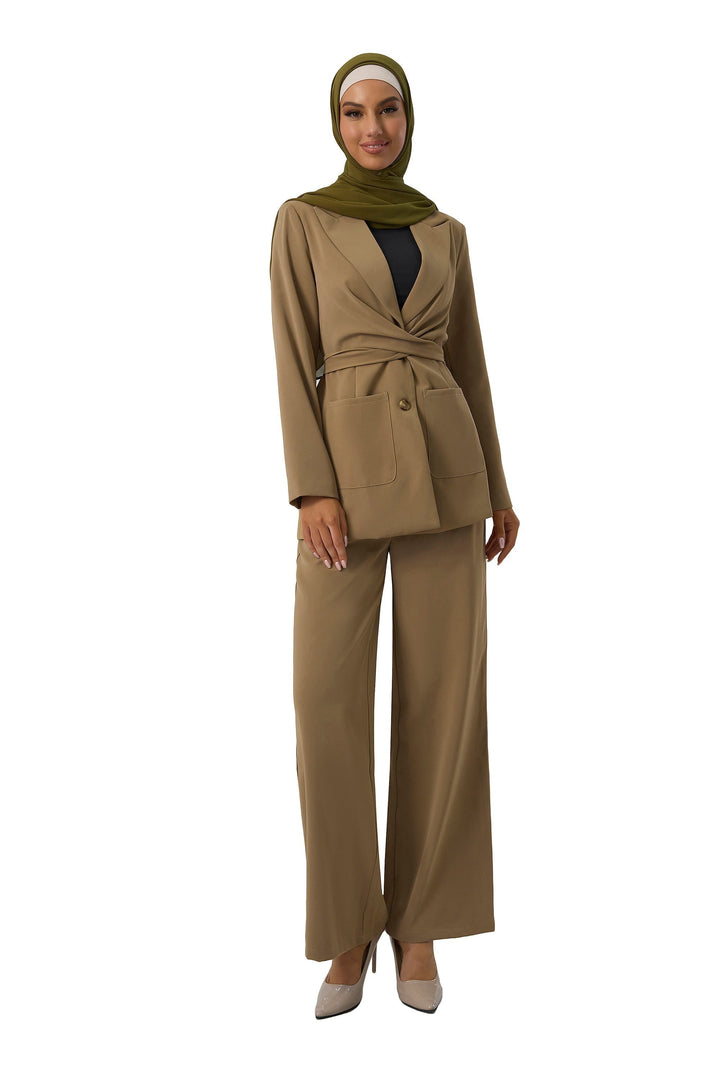 Woman’s taupe jacket and pants suit set paired with a stylish green hijab