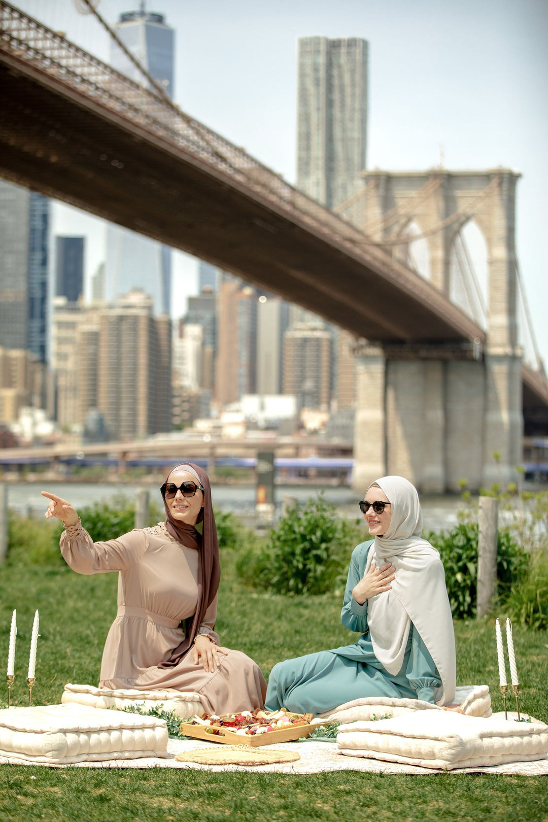 Two women in hijabs enjoying a picnic while wearing a Taupe Lace Tiered Maxi Dress