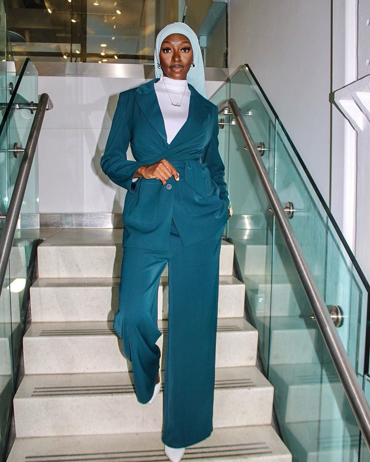 Woman in teal jacket and pants suit set, stylish and elegant clearance outfit