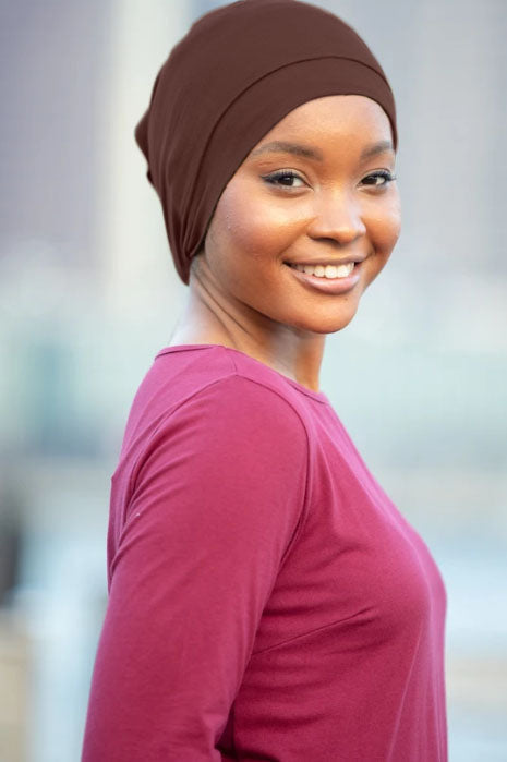 Smiling woman wearing Tube Hijab Underscarf in brown and maroon attire