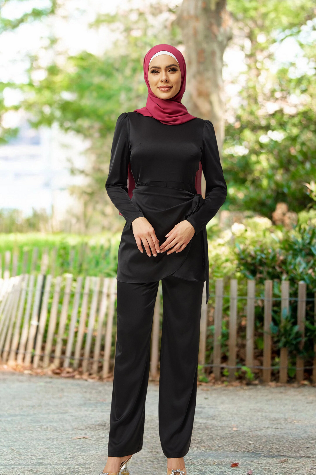 Woman in black modest satin side wrap tunic and pant set