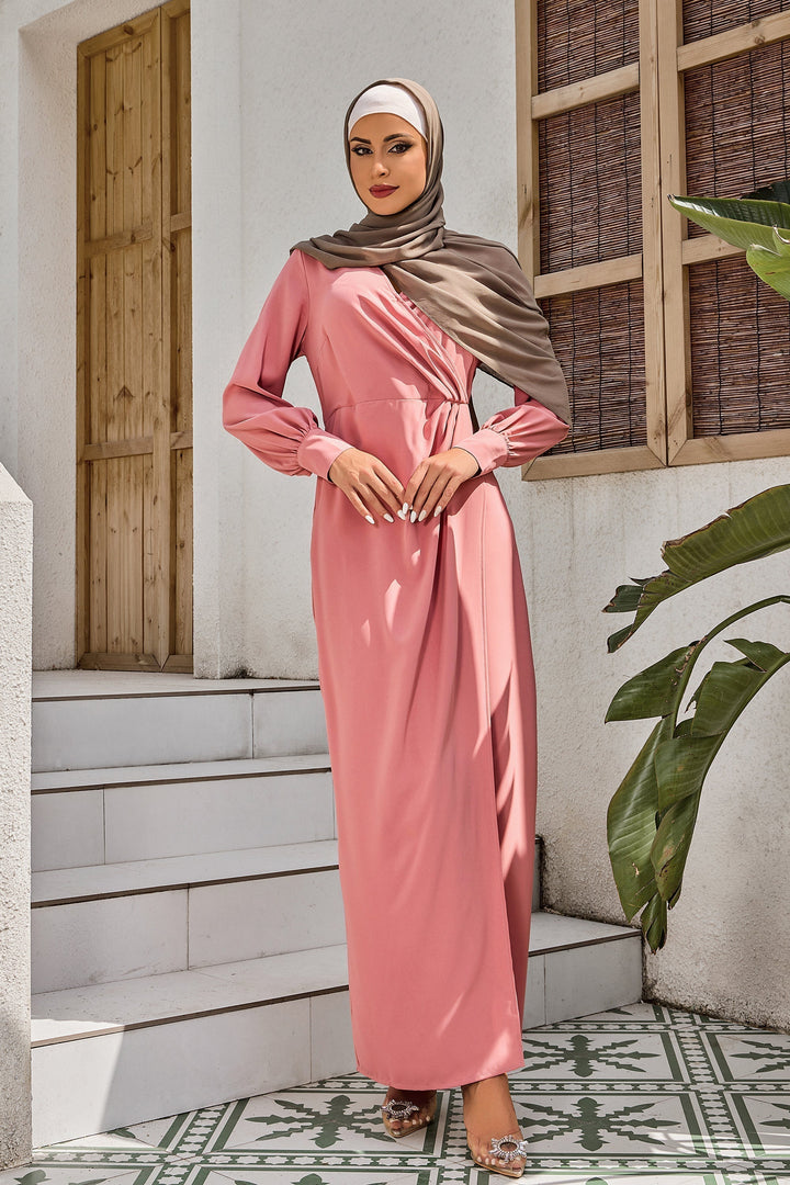 Woman in coral wrap maxi dress and pink hijab