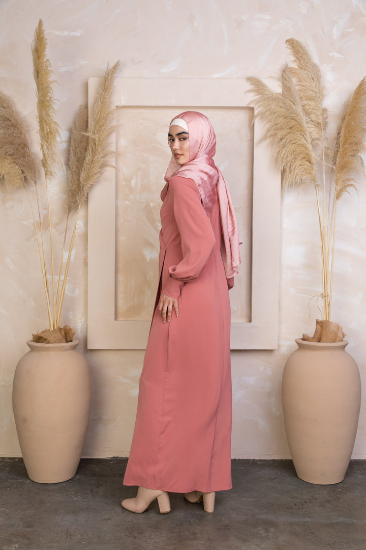 Woman in long pink coral wrap maxi dress and hijab on clearance