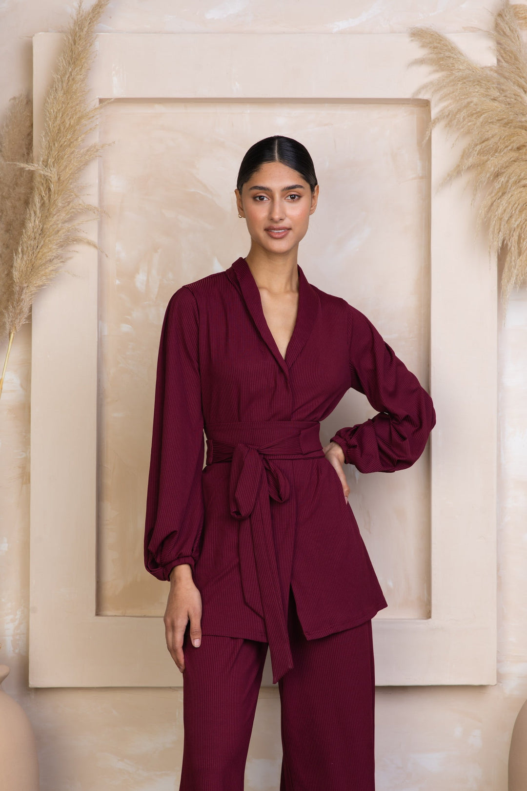 Burgundy wrap-style pantsuit in maroon belted ribbed tunic and pants set