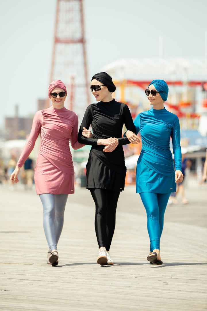 Three women modeling ruched 3-piece modest burkini swimsuit