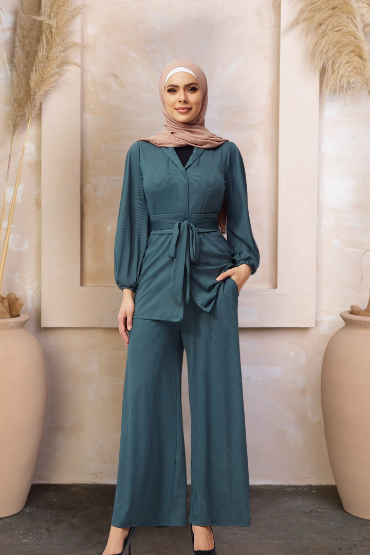 Woman in teal pantsuit and hijab wearing belted ribbed tunic and pants set