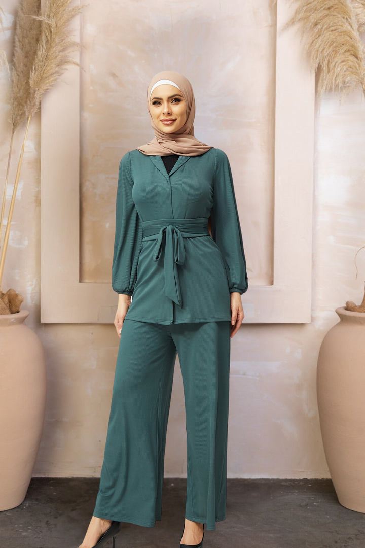 Woman in green pantsuit with hijab in teal belted ribbed tunic set