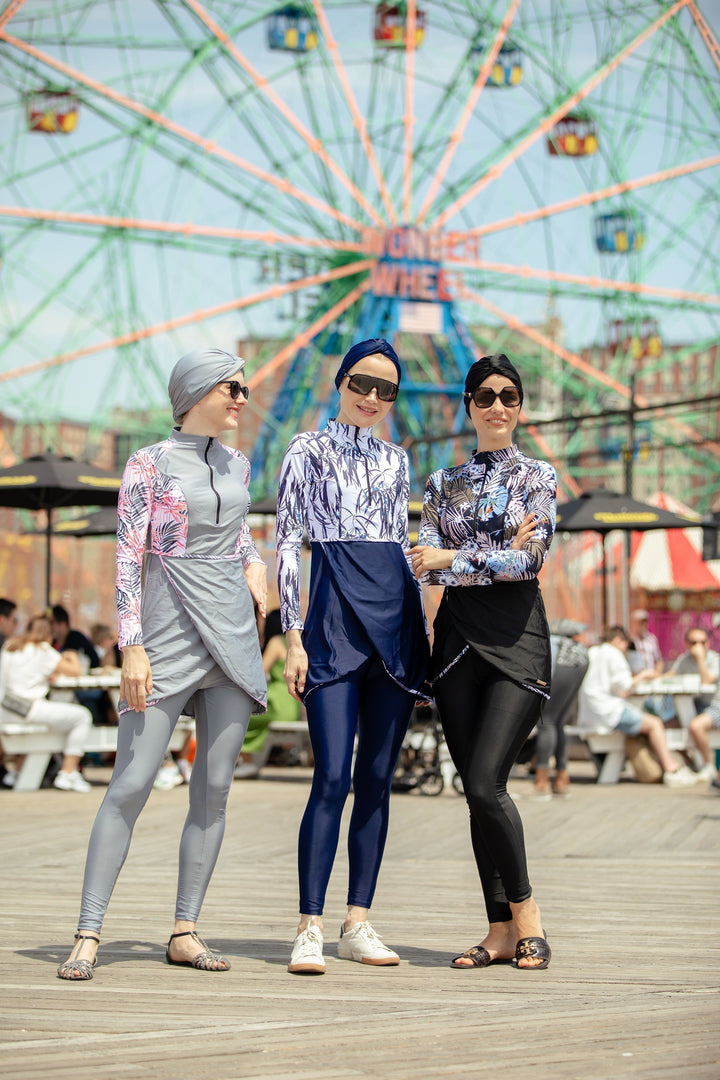 Three women in white and navy floral 3-piece modest swimsuit