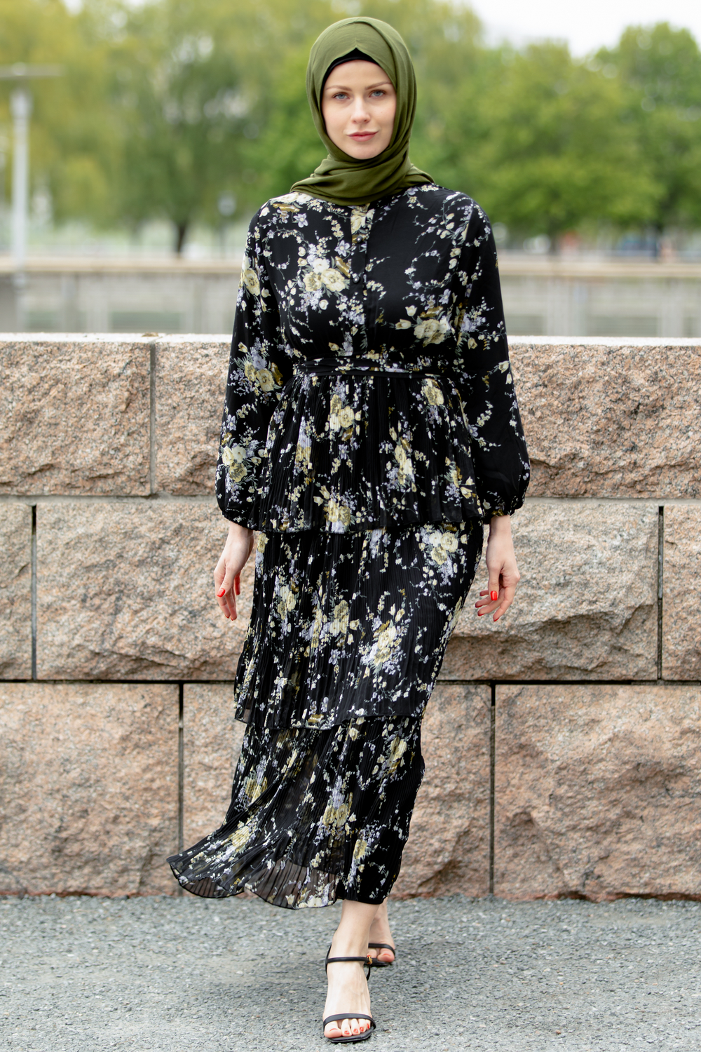 a woman wearing a black and white floral dress