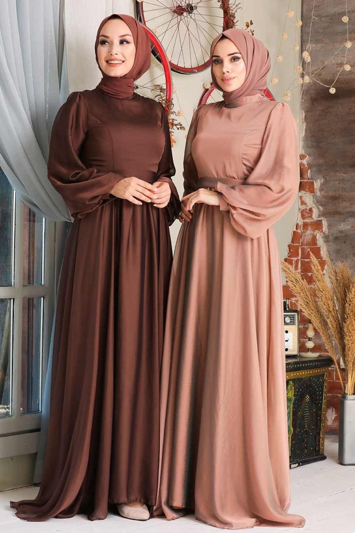 two women in brown dresses standing next to each other