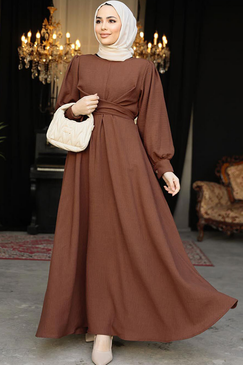 a woman wearing a brown dress and a white purse