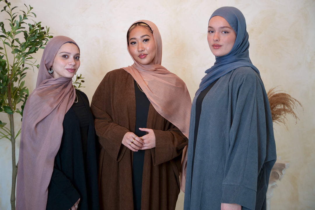 a group of three women standing next to each other