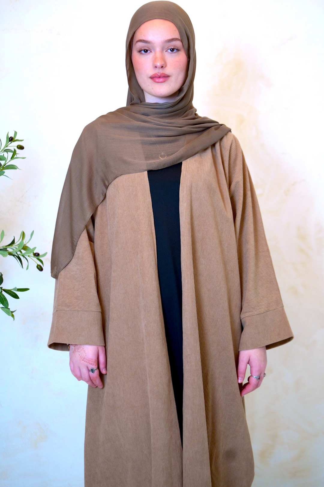 a woman wearing a brown shawl and black dress