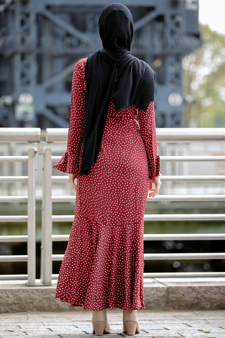 a woman in a red dress and a black shawl