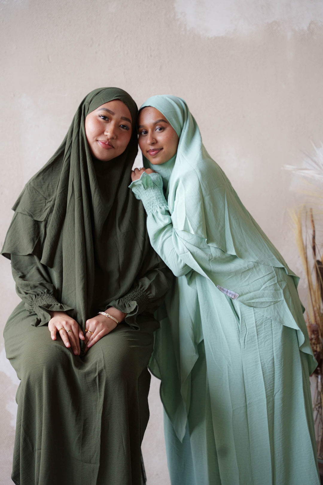 two women in hijabs pose for a picture