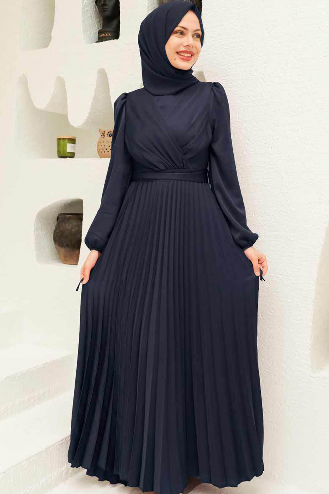 a woman wearing a black dress and a hijab