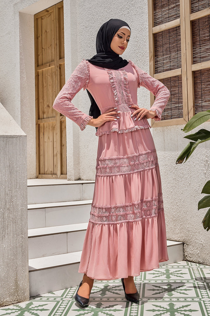 a woman wearing a pink dress and hijab